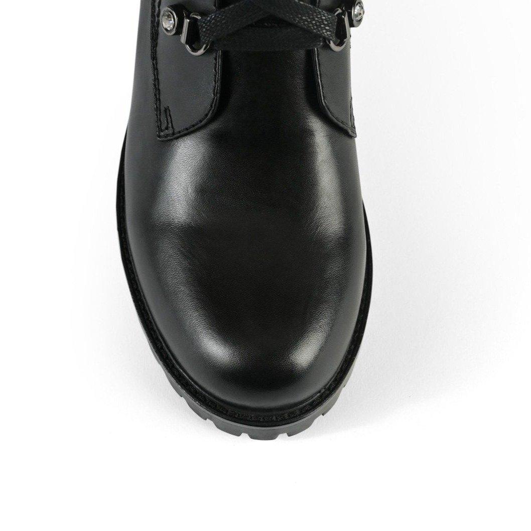 Black combat boots with lace-up design - tip view