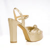 Gold platform sandals with ankle buckle closure - back view